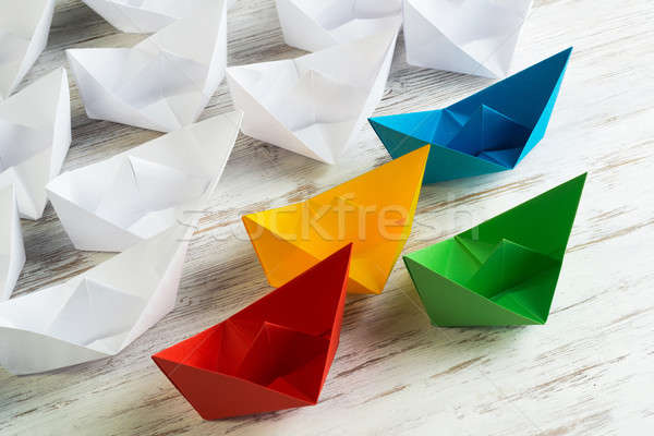 Business leadership concept with white and color paper boats on wooden table Stock photo © adam121