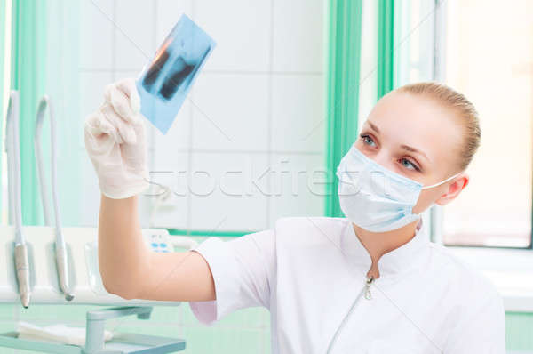 woman doctor in protective mask looking at x-ray Stock photo © adam121