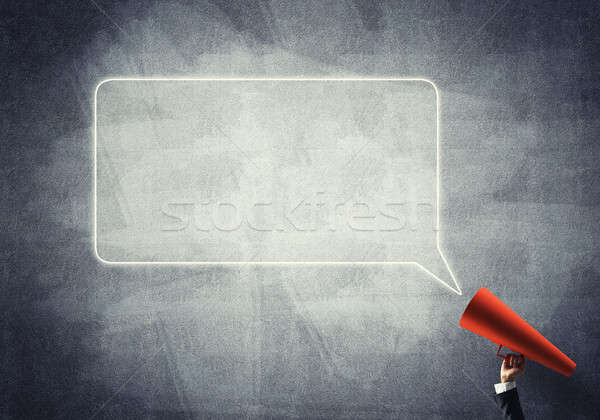 Hand of businesswoman holding red paper trumpet and speech cloud Stock photo © adam121