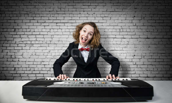 Mad woman play piano Stock photo © adam121