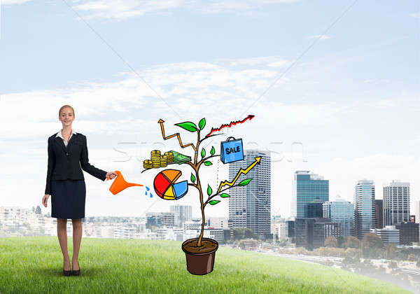 Young businesswoman outdoors watering drawn growth concept with can Stock photo © adam121
