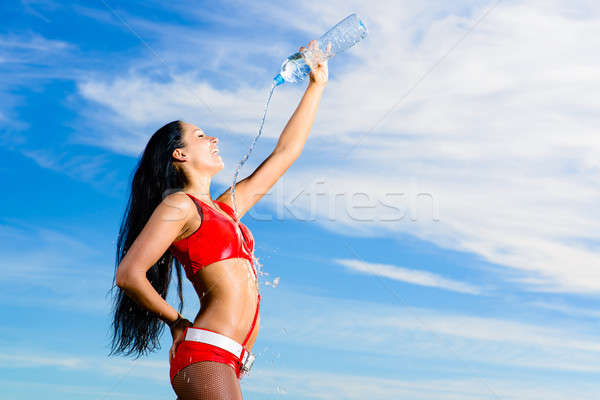 sport girl in red uniform with a bottle of water Stock photo © adam121