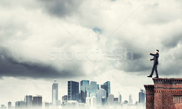 Danger and risk concept with businessman making step from edge Stock photo © adam121