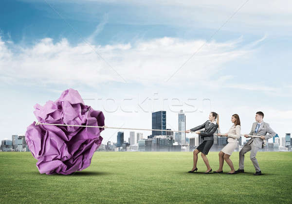 Young business people outdoors and huge paper ball as symbol of  Stock photo © adam121