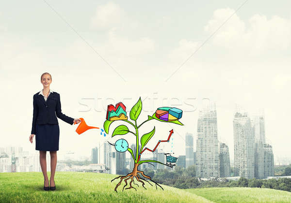 Young businesswoman outdoors watering drawn growth concept with  Stock photo © adam121