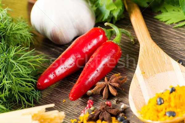 chilli, herbs and spices lie on a wooden surface Stock photo © adam121