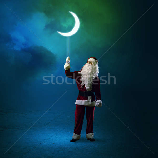 Santa Claus holding a shining moon Stock photo © adam121
