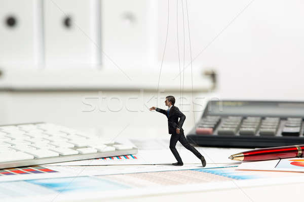 Stock photo: businessman puppet doll is on the desk