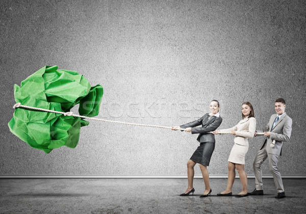 Young business people and huge paper ball as symbol of creativity Stock photo © adam121