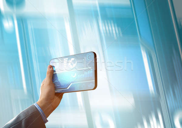 Media technology concept presented by businessman holding tablet with graphs and diagrams Stock photo © adam121