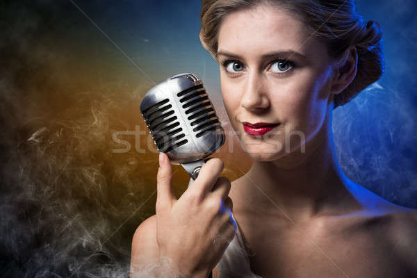 Stock photo: attractive female singer with microphone