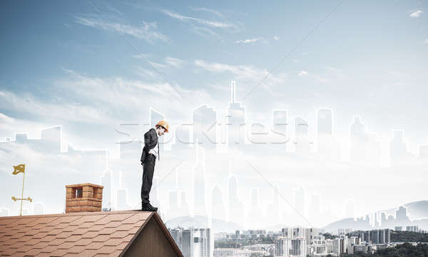 Engineer man standing on roof and looking down. Mixed media Stock photo © adam121