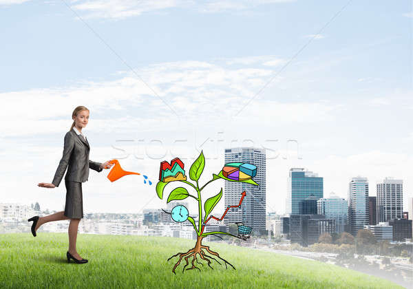 Young businesswoman outdoors watering drawn growth concept with can Stock photo © adam121