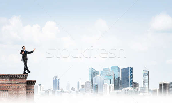 Danger and risk concept with businessman making step from edge Stock photo © adam121