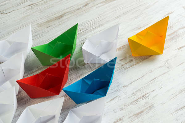 Business leadership concept with white and color paper boats on wooden table Stock photo © adam121