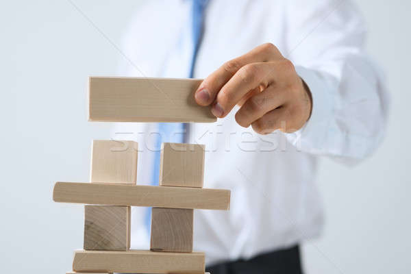 Stock photo: Businessman making tower