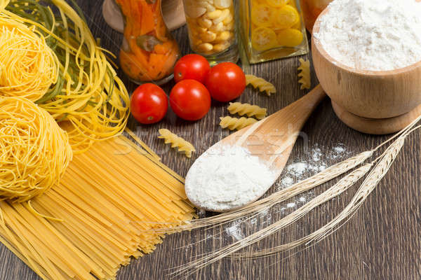 Stock photo: pasta, tomatoes and flour on the spoon