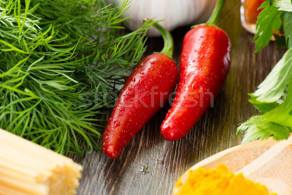 chilli, herbs and spices lie on a wooden surface Stock photo © adam121
