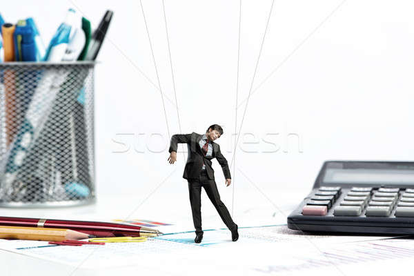 Stock photo: businessman puppet doll is on the desk