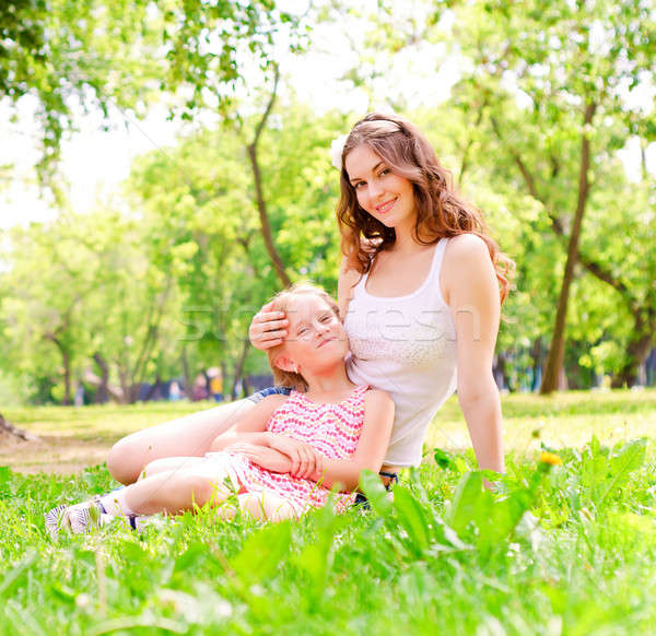 mother and daughter sitting together on the grass Stock photo © adam121