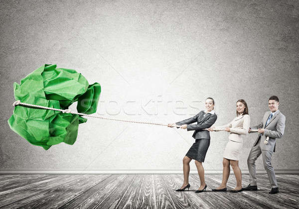 Young business people and huge paper ball as symbol of creativit Stock photo © adam121