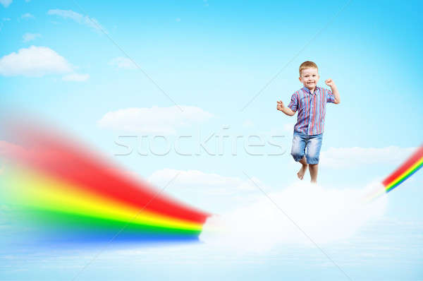 boy jumping on clouds and a rainbow Stock photo © adam121