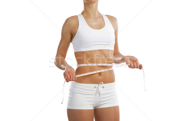 Stock photo: young athletic woman measuring waist