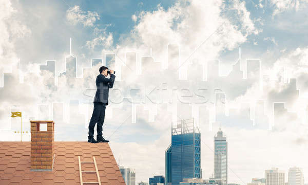 Businessman standing on roof and looking in binoculars. Mixed me Stock photo © adam121