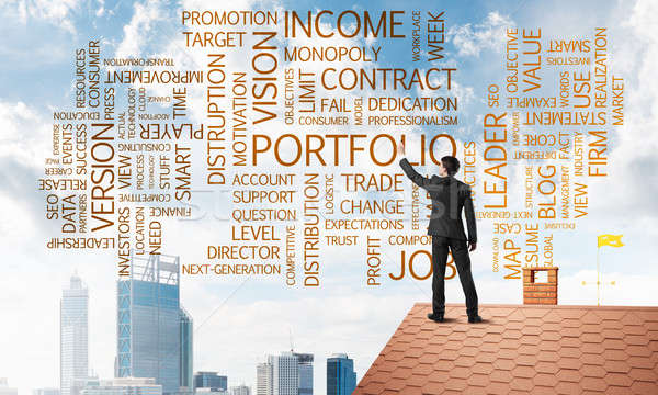 Young businessman standing on house roof and writing leadership skill concept. Mixed media Stock photo © adam121