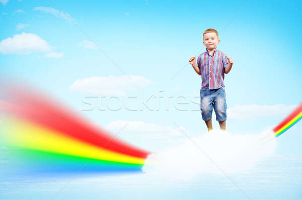 boy jumping on clouds and a rainbow Stock photo © adam121