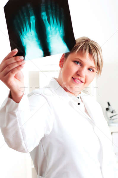 Stock photo: Female medic looking at x-rays