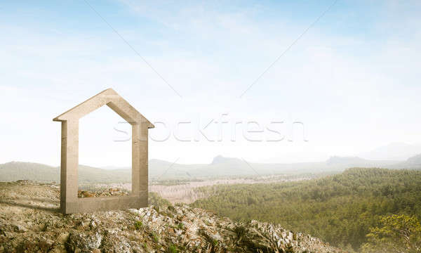 Stock photo: Conceptual image of concrete home sign on hill and natural lands