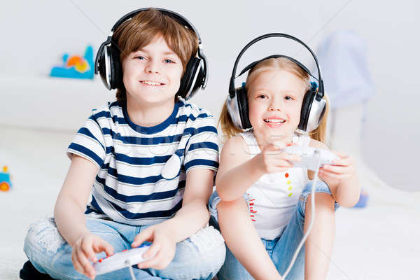 cute boy and girl playing gaming console Stock photo © adam121