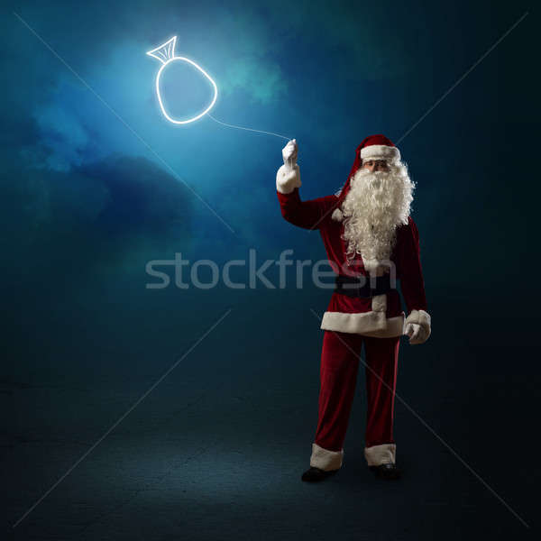 Santa Claus is holding a shining bag Stock photo © adam121