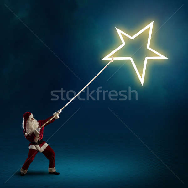 Santa Claus pulls the shining star Stock photo © adam121