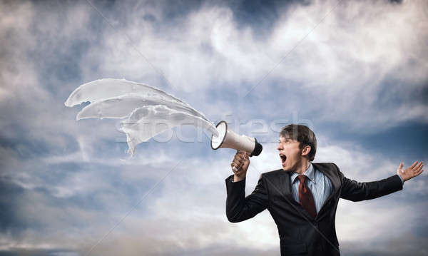 Stock photo: businessman shouting into a megaphone