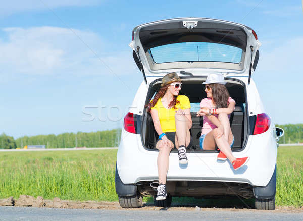 young attractive woman sitting in the open trunk Stock photo © adam121