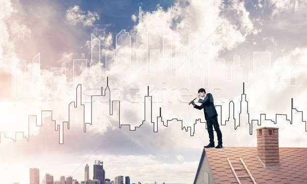 Engineer man standing on roof and looking in spyglass. Mixed med Stock photo © adam121