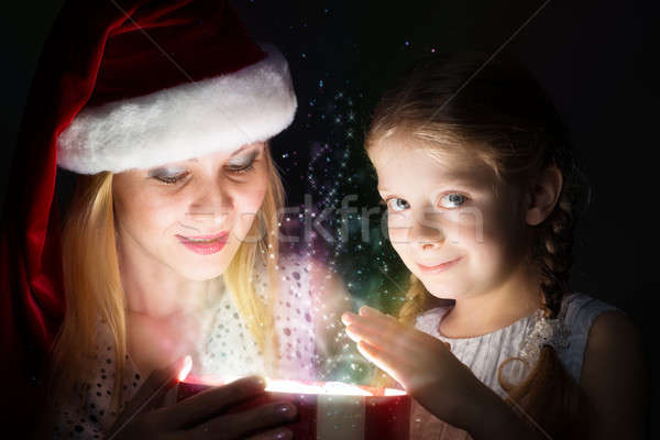 Stock photo: mother and daughter opened a box with a gift