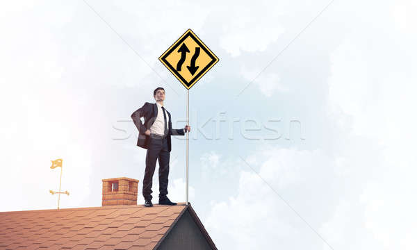 Mister boss on brick roof with sign in hands. Mixed media Stock photo © adam121
