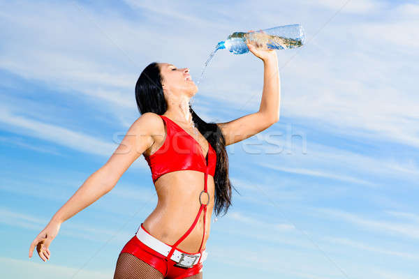 sport girl in red uniform with a bottle of water Stock photo © adam121