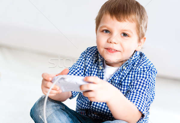 Boy playing on a game console Stock photo © adam121