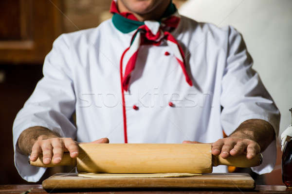 Cook rolls out the dough on a board Stock photo © adam121