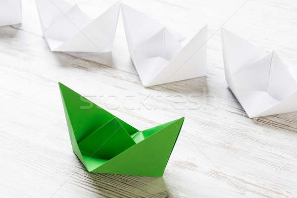 Business leadership concept with white and color paper boats on wooden table Stock photo © adam121