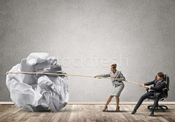 Businesspeople pulling with effort big crumpled ball of paper as creativity sign Stock photo © adam121