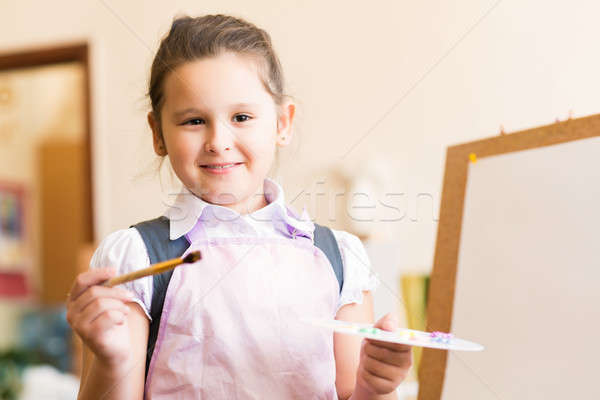 Portrait of Asian girl in apron painting Stock photo © adam121