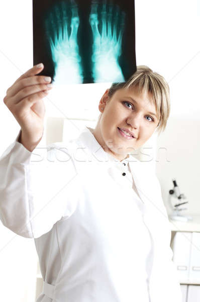 Female medic looking at x-rays Stock photo © adam121