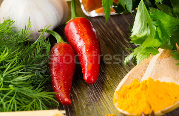 chilli, herbs and spices lie on a wooden surface Stock photo © adam121