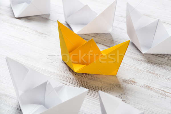 Business leadership concept with white and color paper boats on wooden table Stock photo © adam121