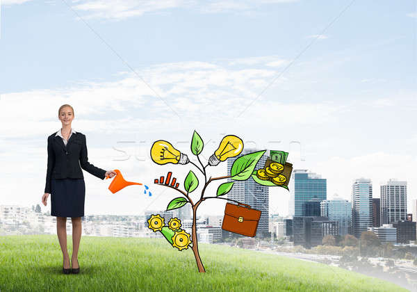 Young businesswoman outdoors watering drawn growth concept with can Stock photo © adam121